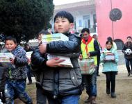 2016年1月8日下午,在駐馬店市汝南縣三門閘街道大新莊小學(xué)校院內(nèi)，駐馬店市陽(yáng)光助學(xué)協(xié)會(huì)負(fù)責(zé)人及志愿者、大新莊學(xué)校師生、學(xué)生家長(zhǎng)歡聚一堂，舉行了“陽(yáng)光助學(xué)愛(ài)心圖書(shū)室”捐贈(zèng)儀式。圖為學(xué)生和志愿者一起搬運(yùn)新書(shū)