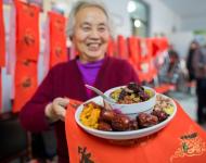 1月4日，內(nèi)蒙古呼和浩特市玉泉區(qū)清泉街社區(qū)一位老人在展示臘八粥食材。當(dāng)日，呼和浩特市玉泉區(qū)清泉街社區(qū)舉辦“溫暖臘八粥 濃濃鄰里情”活動，喜迎即將到來的“臘八節(jié)”。新華社發(fā) 丁根厚 攝